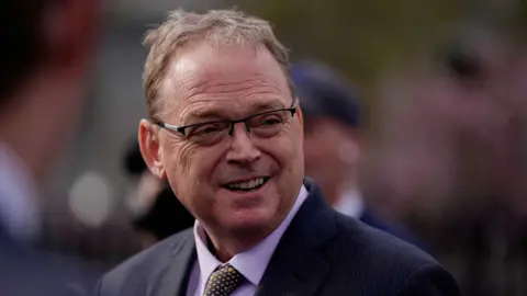 Reuters Kevin Hassett, wearing glasses looks to the side of the camera.