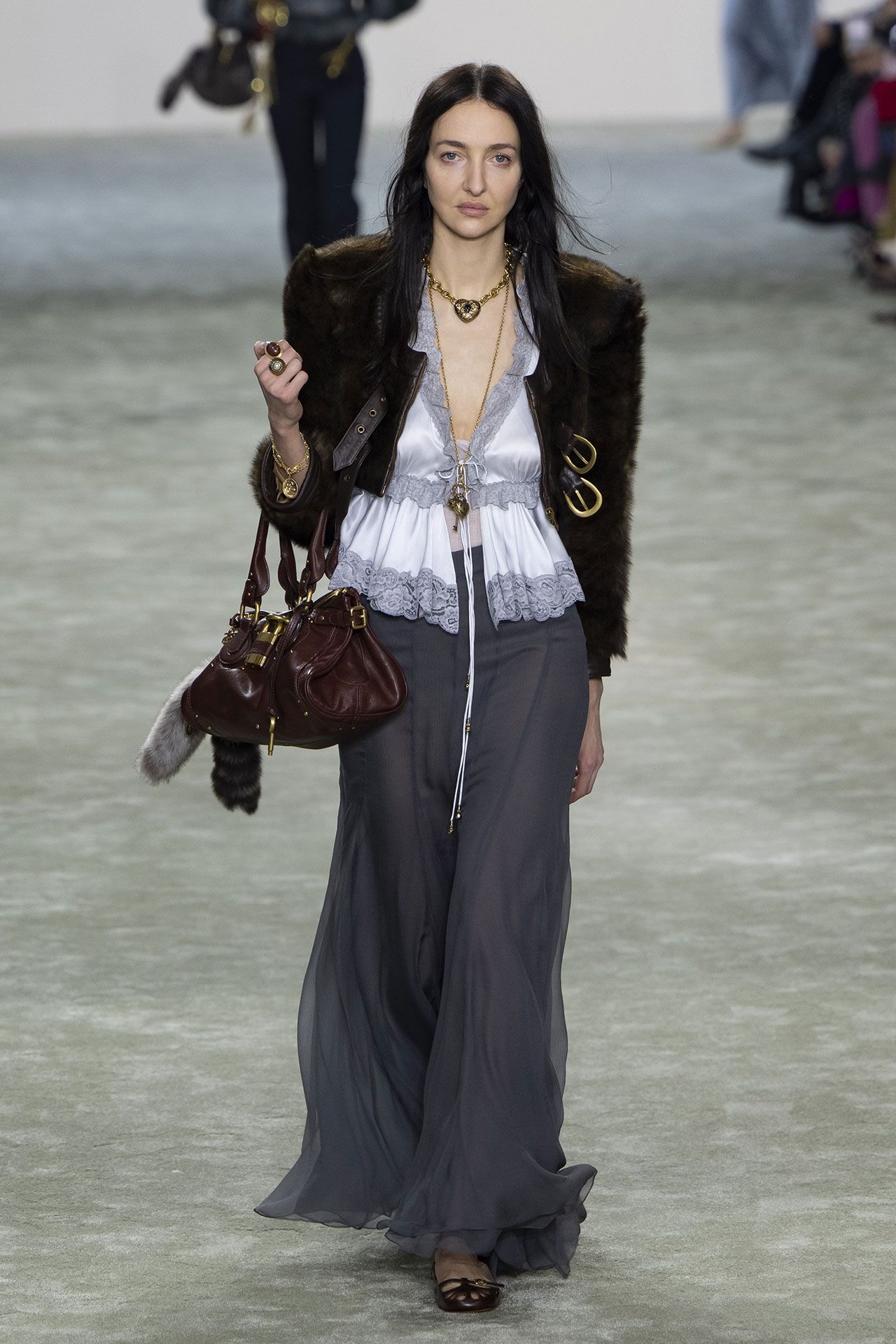 Image may contain Karine Berger Accessories Bag Handbag Clothing Pants Coat Jacket Adult Person Fashion and Purse