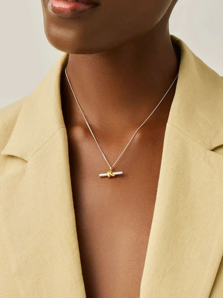 Image may contain: Accessories, Pendant, Jewelry, Necklace, Body Part, Person, and Shoulder