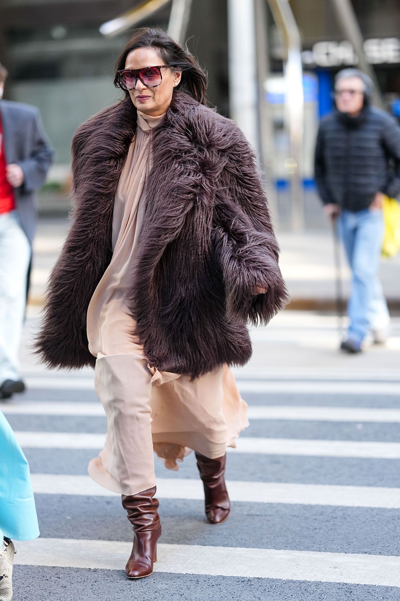 Image may contain Clothing Coat Pedestrian Person Adult Fur Accessories Bag and Handbag