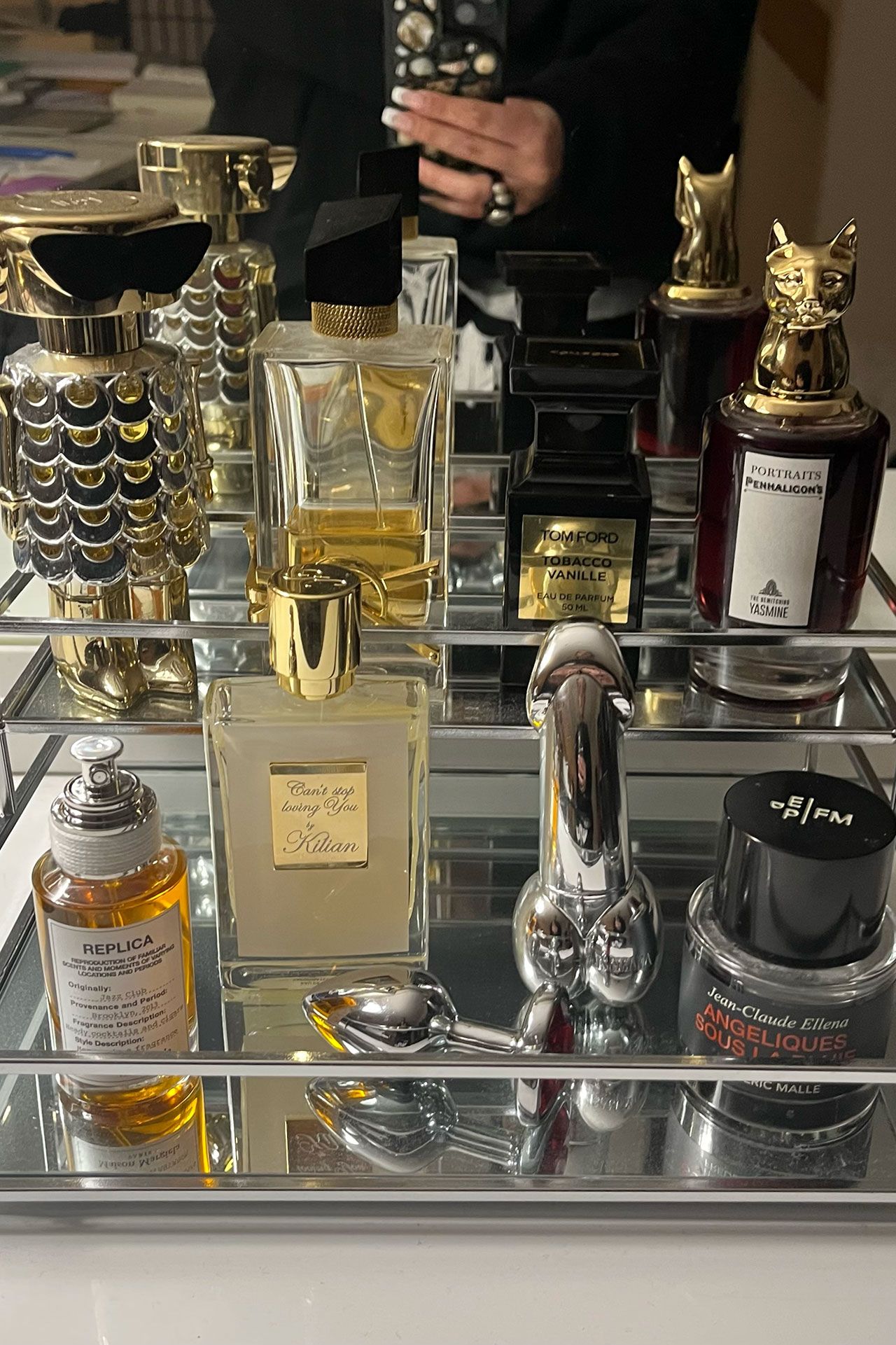 Image may contain Bottle Cosmetics Adult Person Perfume Electronics Remote Control Accessories Jewelry and Ring