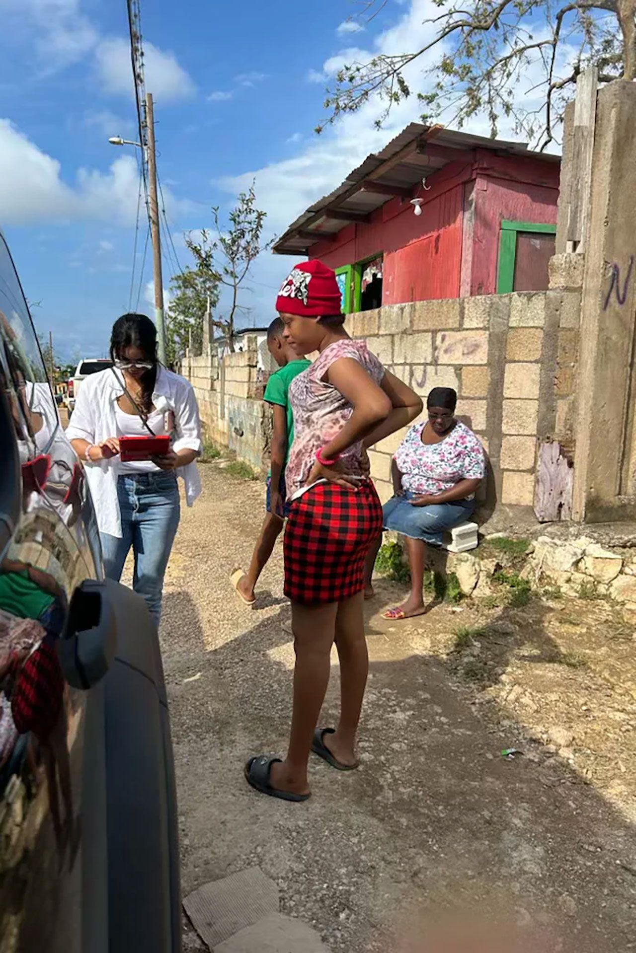 Image may contain Salma Kikwete Person Adult Clothing Footwear Sandal Outdoors Skirt Shoe Jeans and Pants