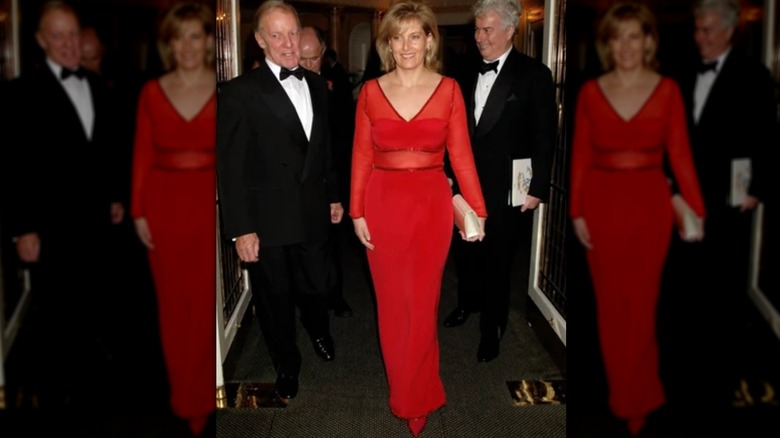 Sophie, Duchess of Edinburgh, walking in a red dress with men in tuxedos behind her