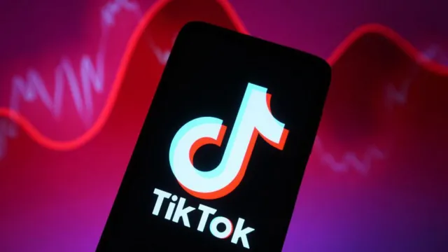 Getty Images TikTok logo shown on a smartphone against a backdrop illustrating rising and falling reports with a red line