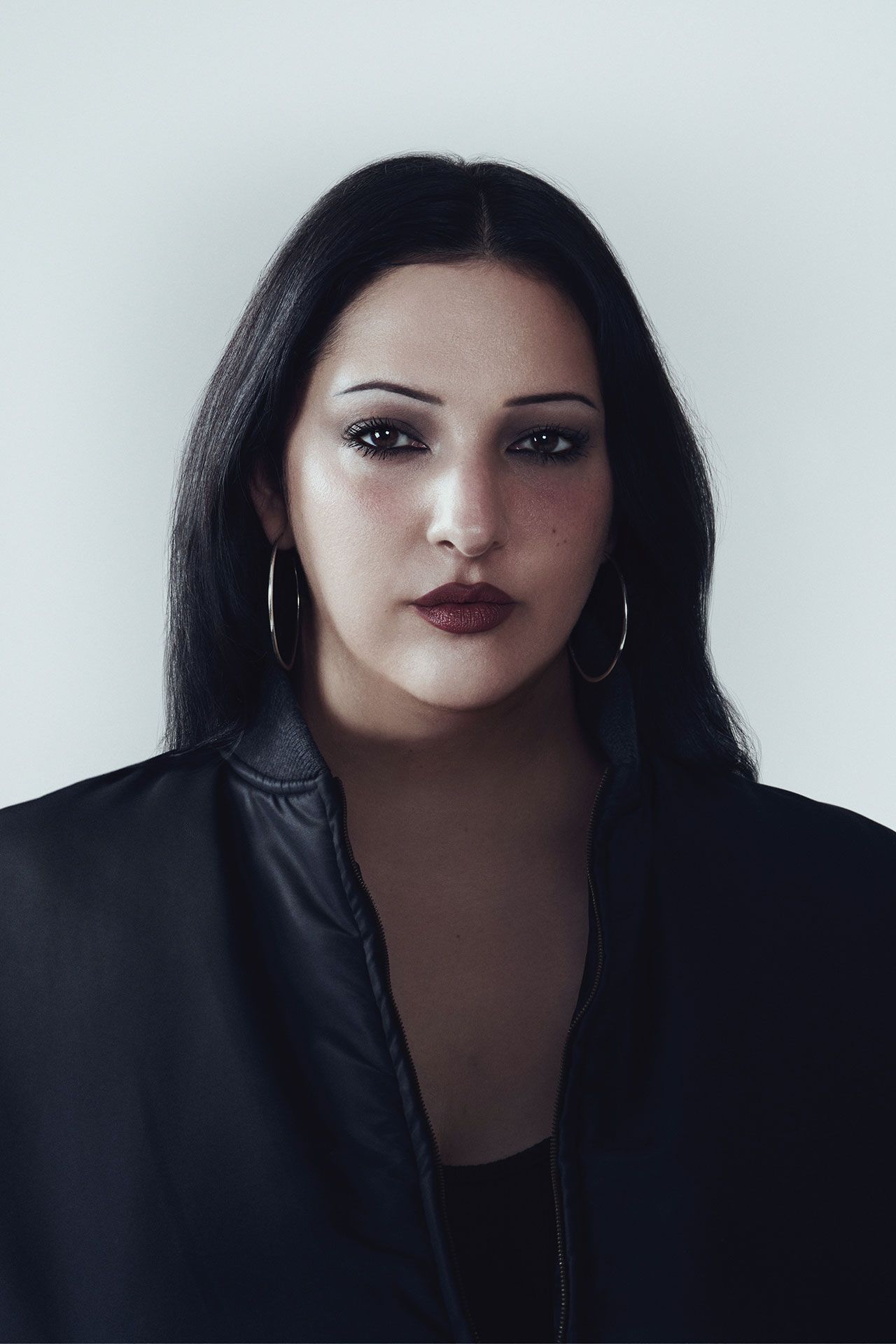 Image may contain Face Head Person Photography Portrait Adult Body Part Neck Happy Smile Black Hair and Hair