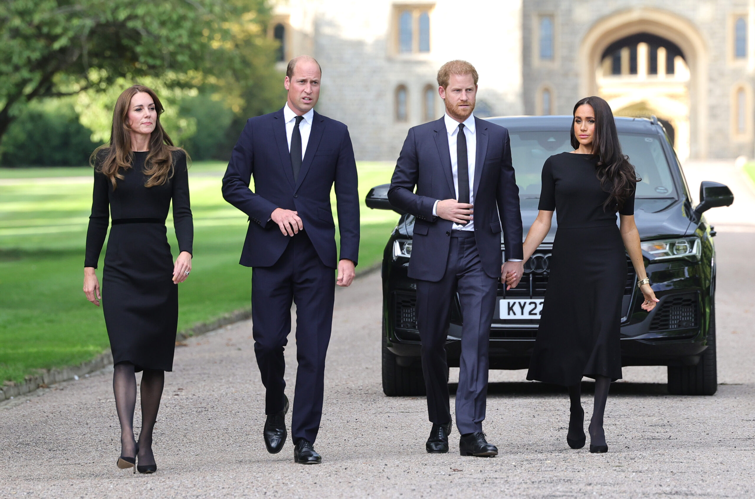 Catherine, Princess of Wales, Prince William, Prince of Wales, Prince Harry, Duke of Sussex, and Meghan, Duchess of Sussex, walk outside Windsor Castle.