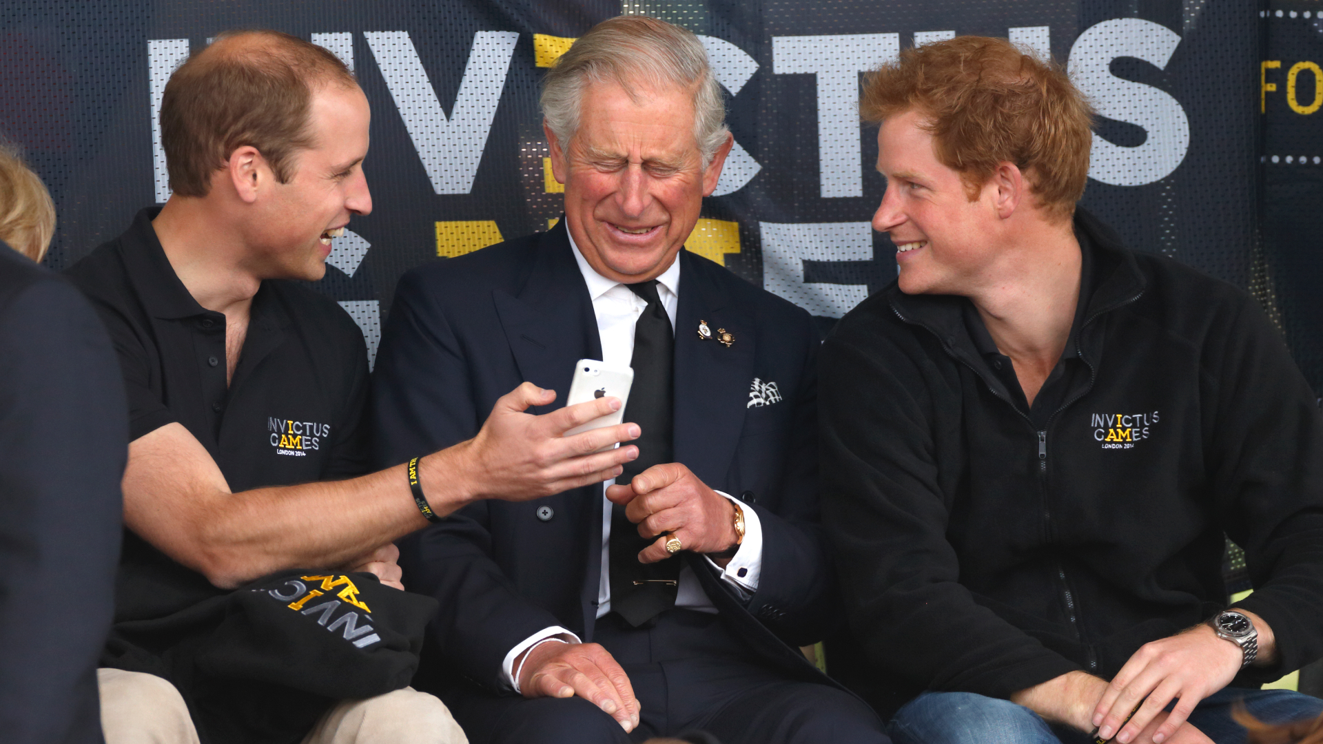 Prince William, Prince Harry, King Charles using an iPhone