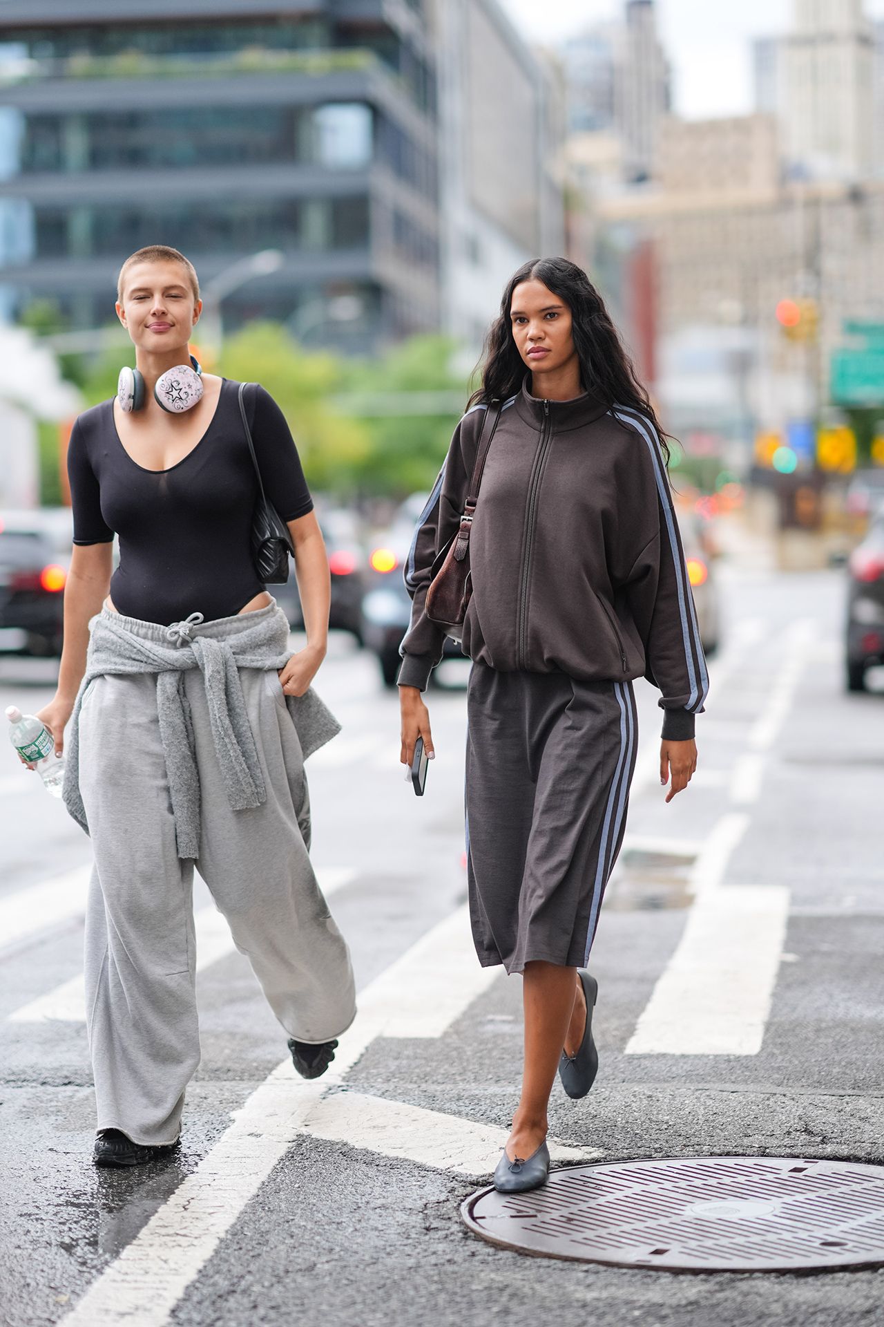 Image may contain Pedestrian Person Walking Body Part Hand Adult Clothing Hoodie Knitwear Sweater and Sweatshirt