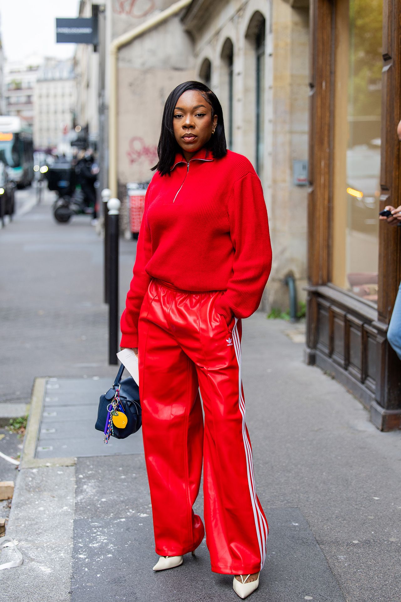 Image may contain Person Standing Pedestrian Adult Clothing Pants Head Face Black Hair and Hair