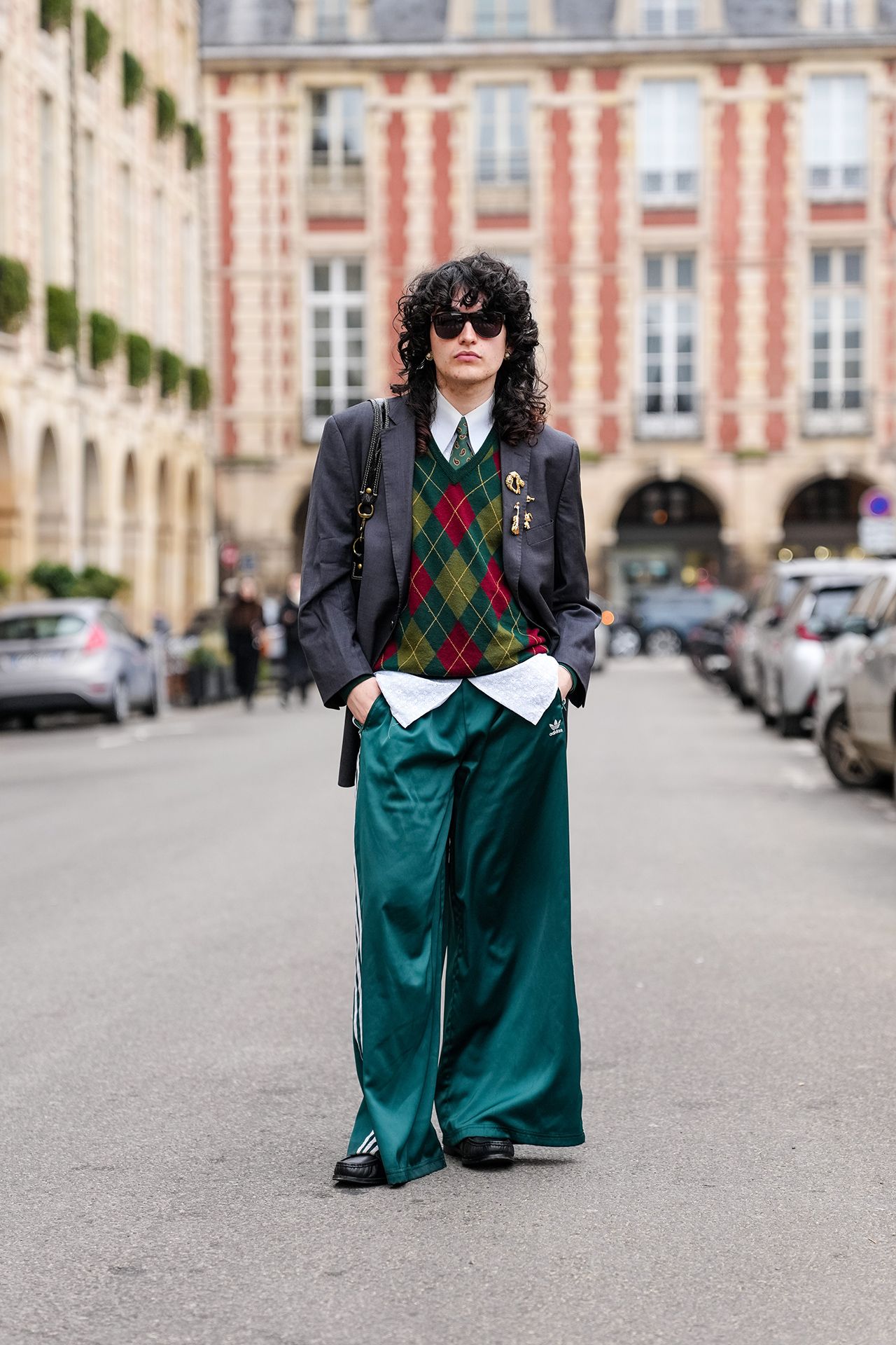 Image may contain Curly Hair Hair Person Adult Car Transportation Vehicle Accessories Formal Wear and Tie