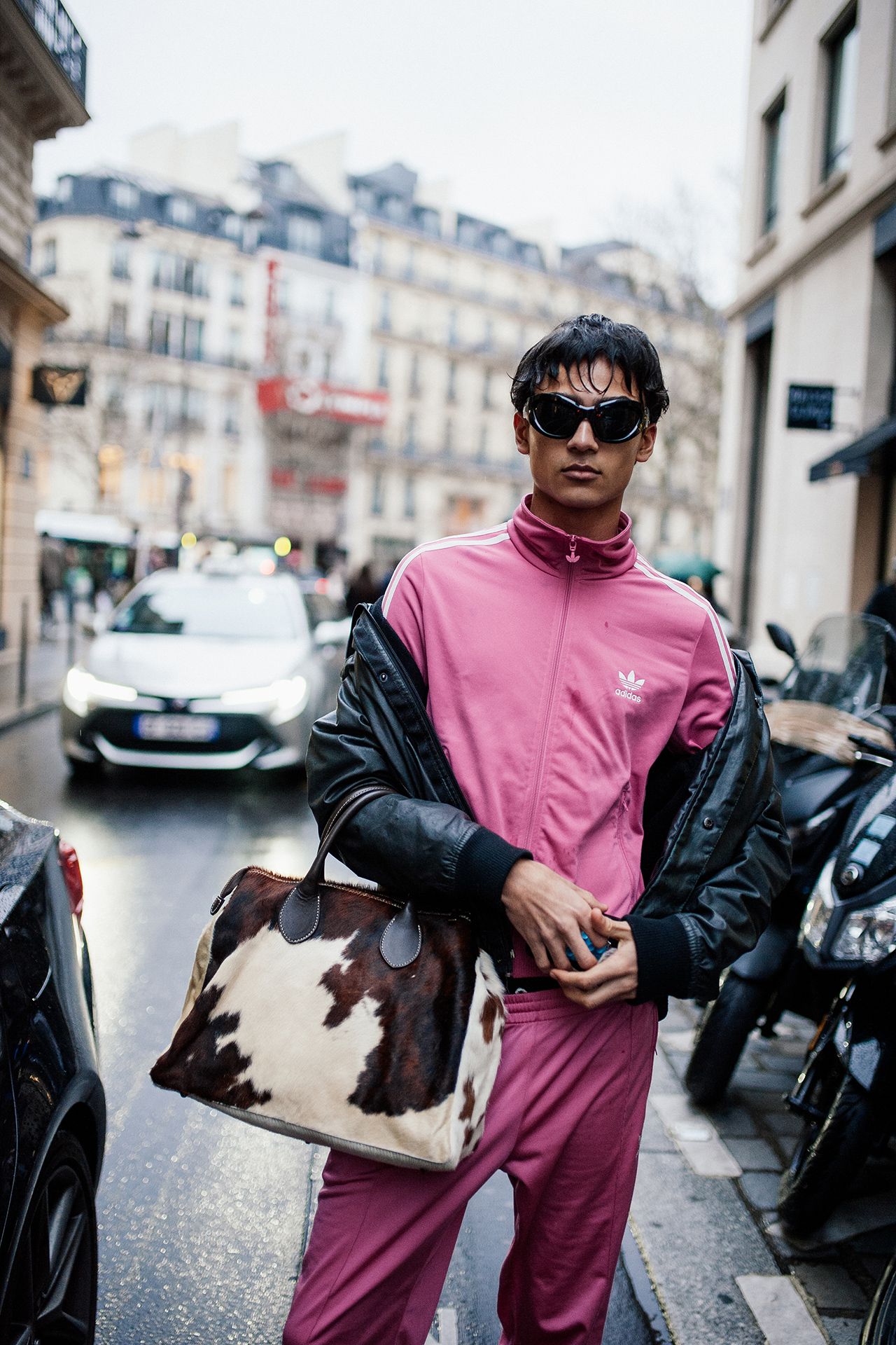 Image may contain Clothing Sleeve Accessories Bag Handbag Adult Person Car Transportation Vehicle and Motorcycle