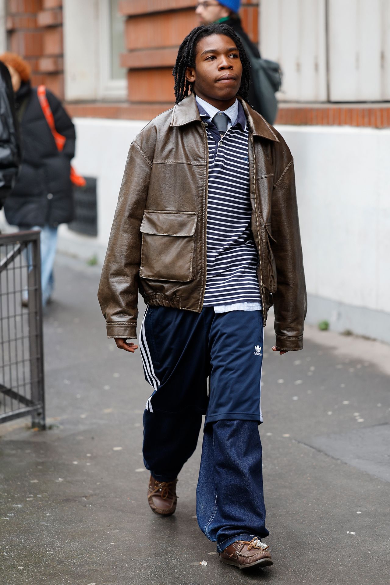 Image may contain Clothing Coat Jacket Pants Adult Person Pedestrian Accessories Bag Handbag and Jeans