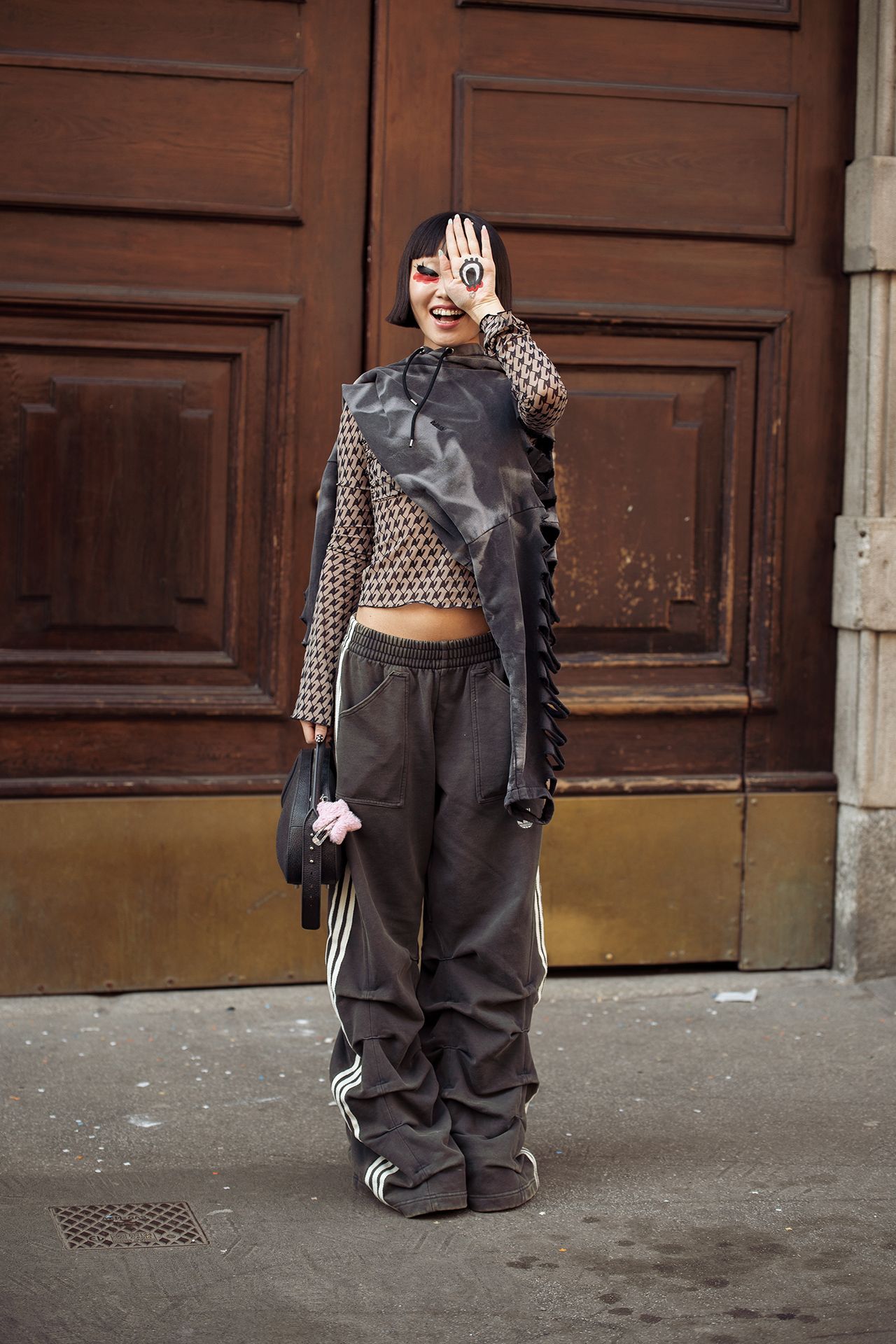 Image may contain Alice Lee Clothing Pants Braid Hair Person Coat Adult Accessories Bag and Handbag