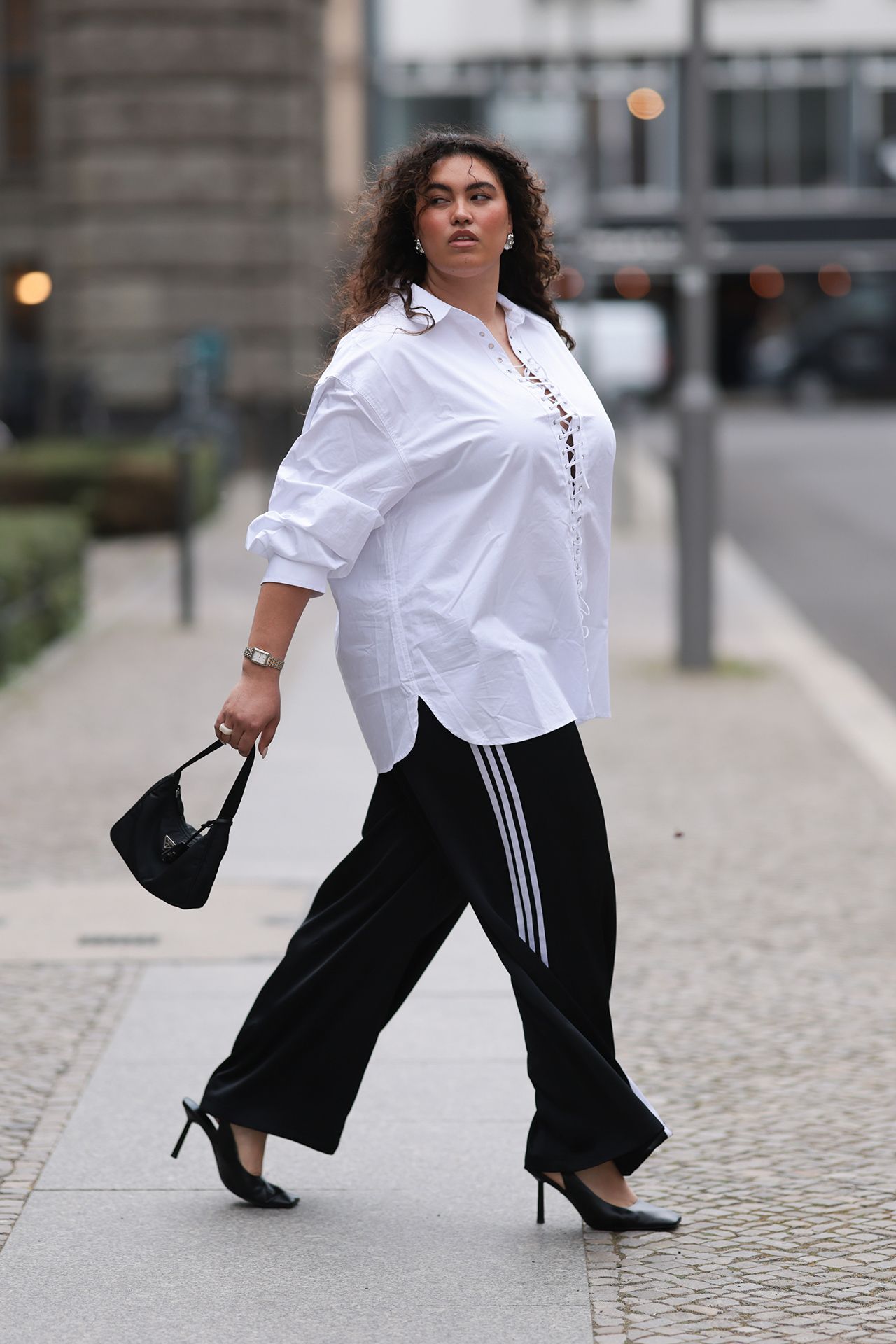 Image may contain Pedestrian Person Clothing Pants Adult Accessories Bag Handbag Sleeve Footwear and High Heel