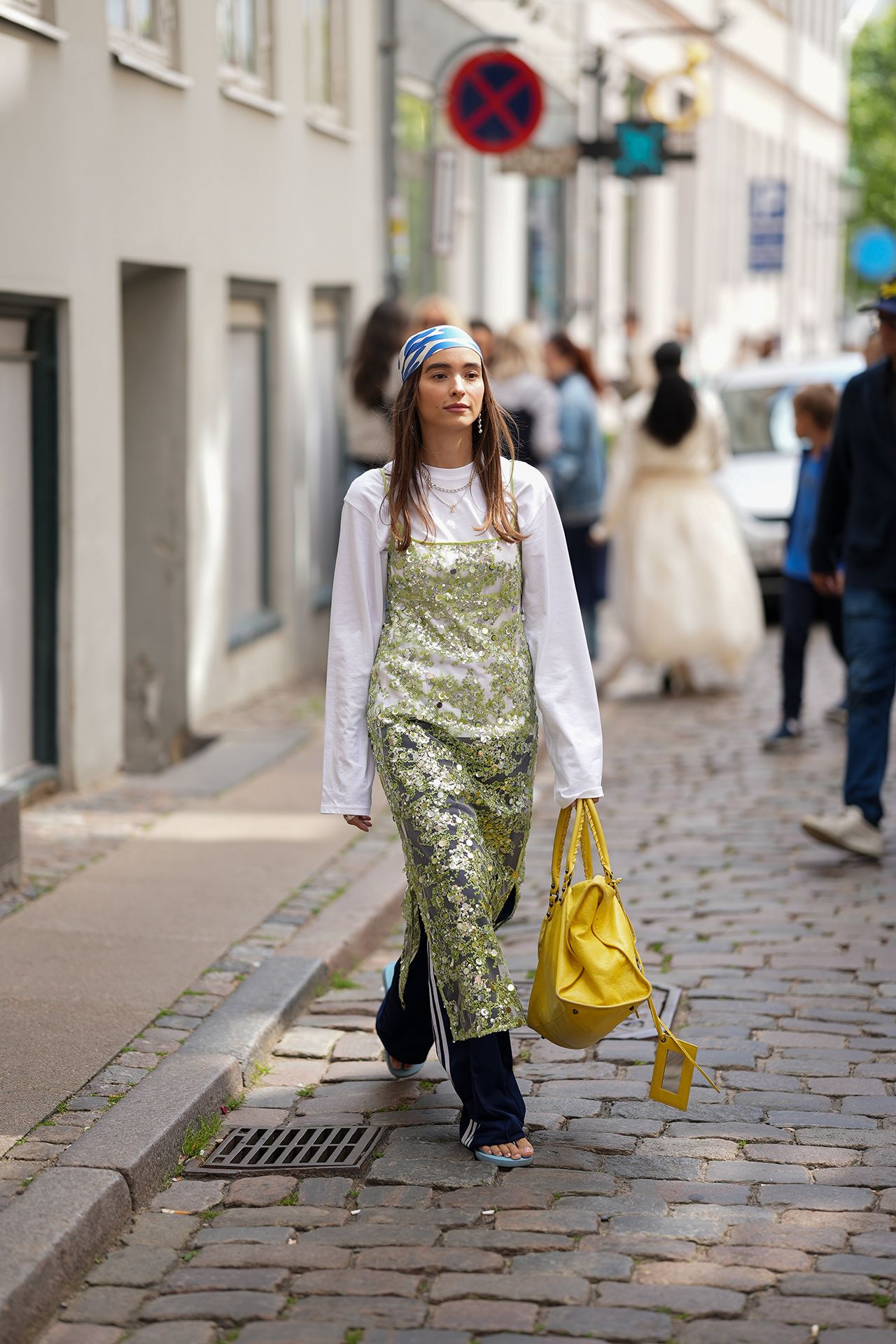 Image may contain Pedestrian Person Clothing Pants Adult Accessories Bag Handbag Wedding Footwear Shoe and Face