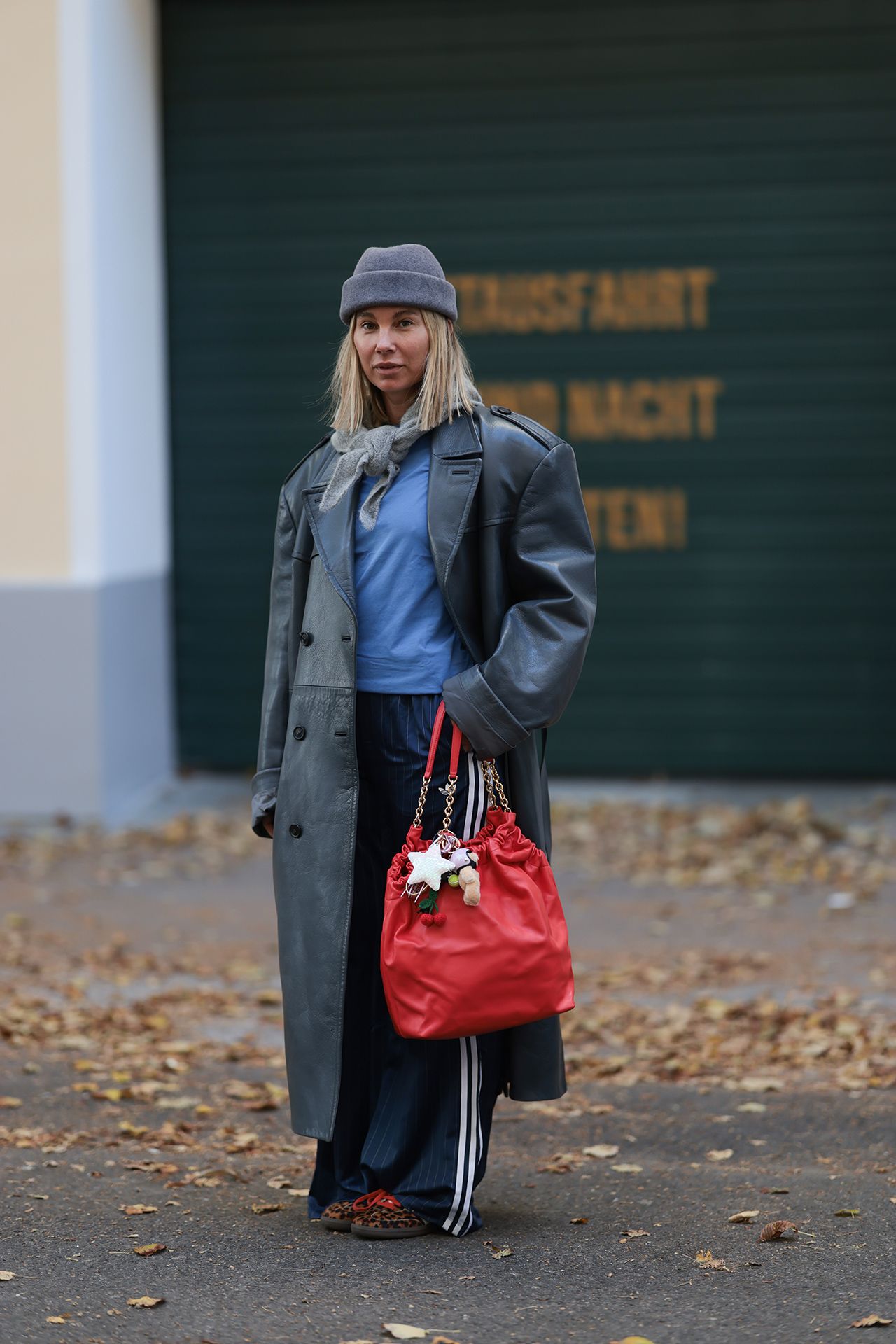 Image may contain Clothing Coat Accessories Bag Handbag Purse and Pants