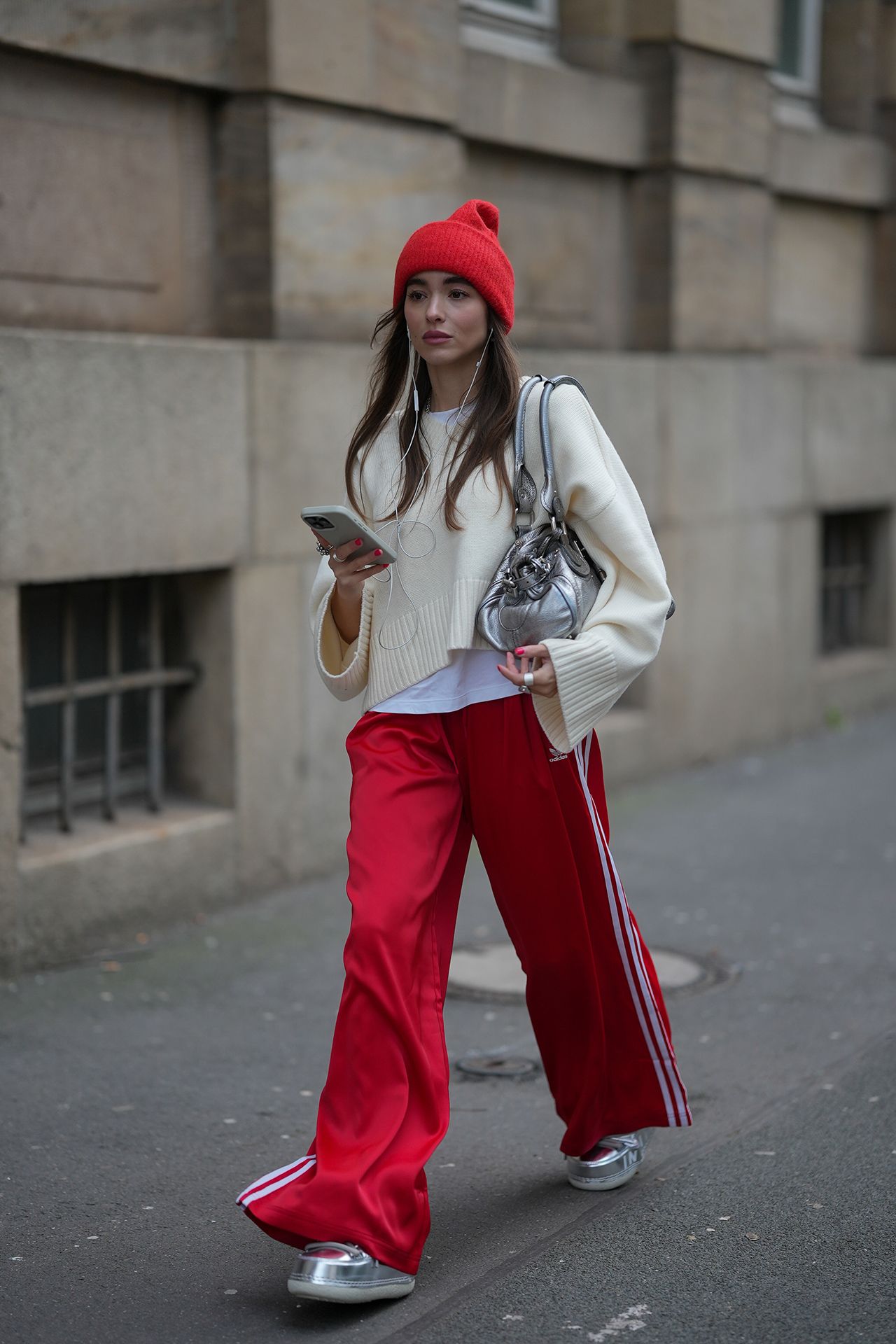 Image may contain Clothing Pants Person Walking Accessories Bag Handbag Teen Coat City Face Head Hat and Cap