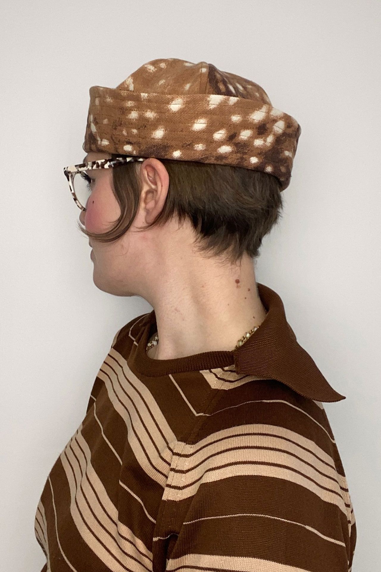 Image may contain Body Part Face Head Neck Person Clothing Hat Adult and Cap