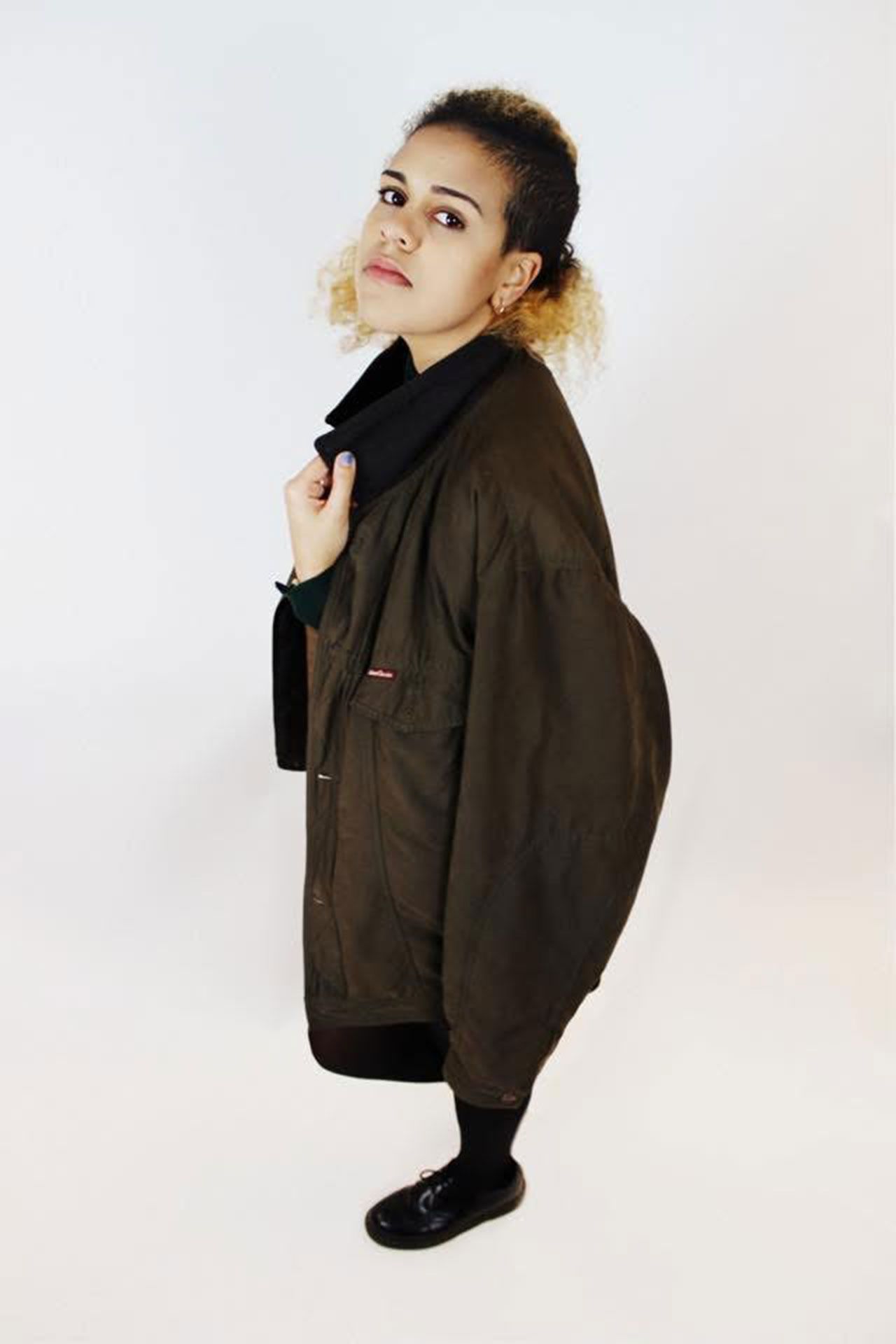 Image may contain Clothing Coat Jacket Adult Person Face Head Photography Portrait Overcoat and Long Sleeve