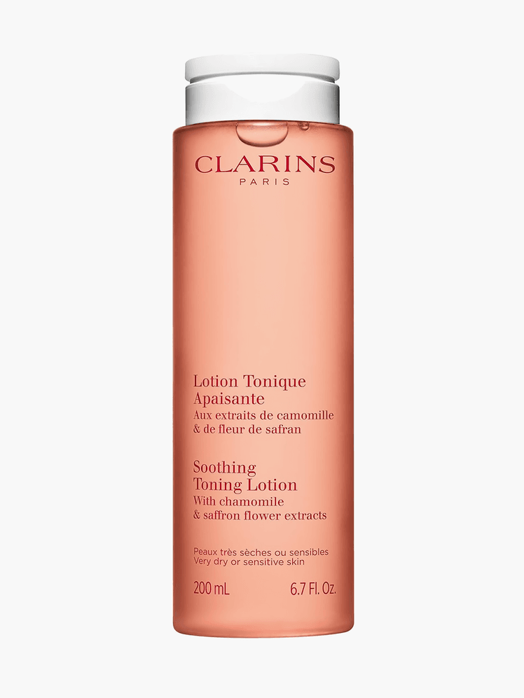 Soothing Toning Lotion in branded clear orange bottle with white cap on light gray background