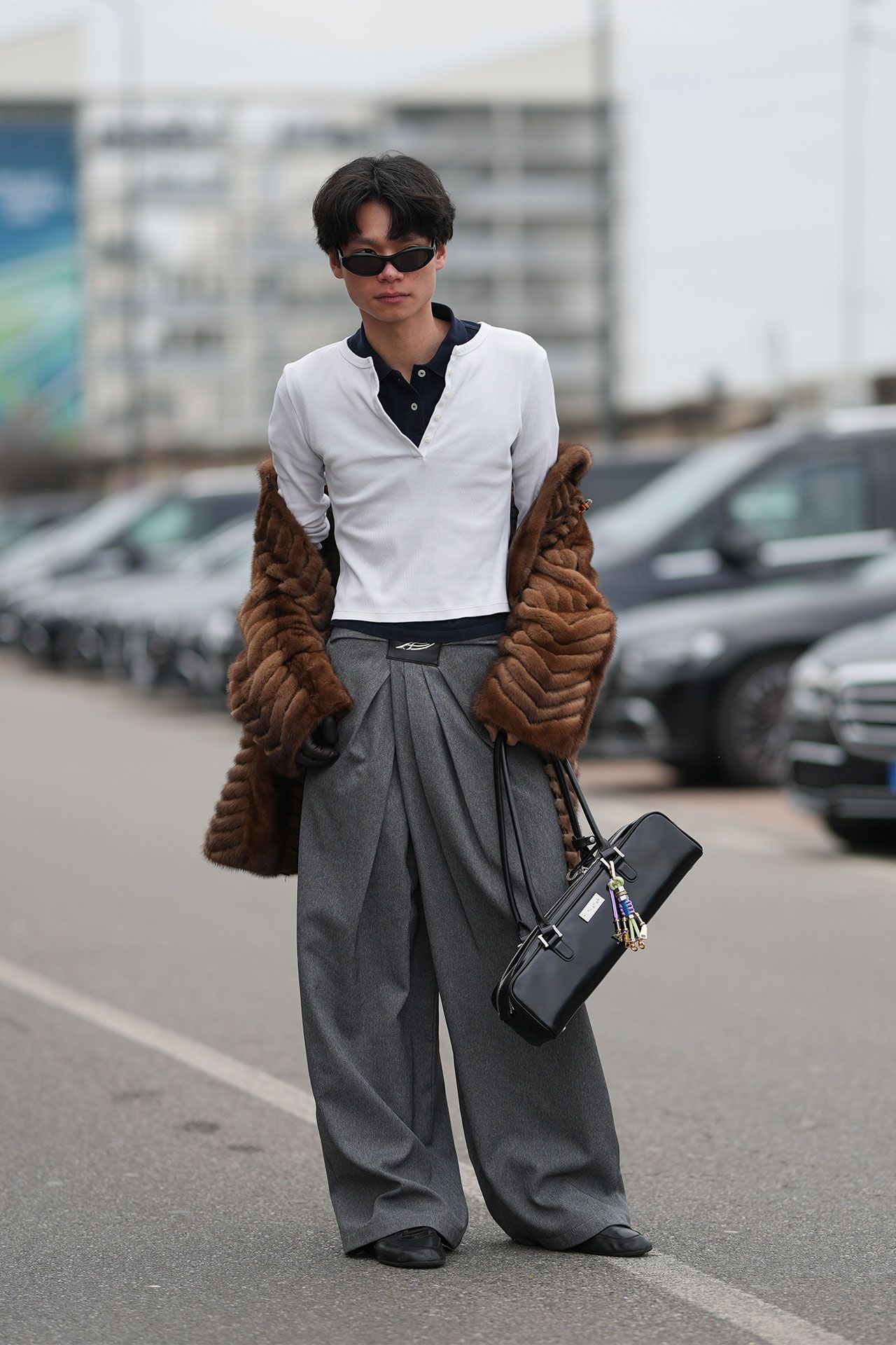 Image may contain Clothing Pants Sleeve Accessories Bag Handbag Adult Person Blazer Coat Jacket and Car