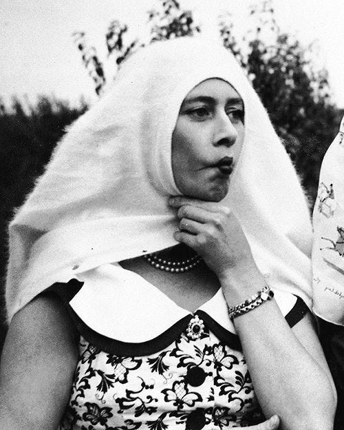 This may contain: an old black and white photo of two women with headscarves on their heads