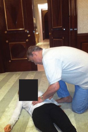 Undated handout image issued by the US Department of Justice of a photograph appearing to show Andrew Mountbatten-Windsor crouched over an unidentified woman