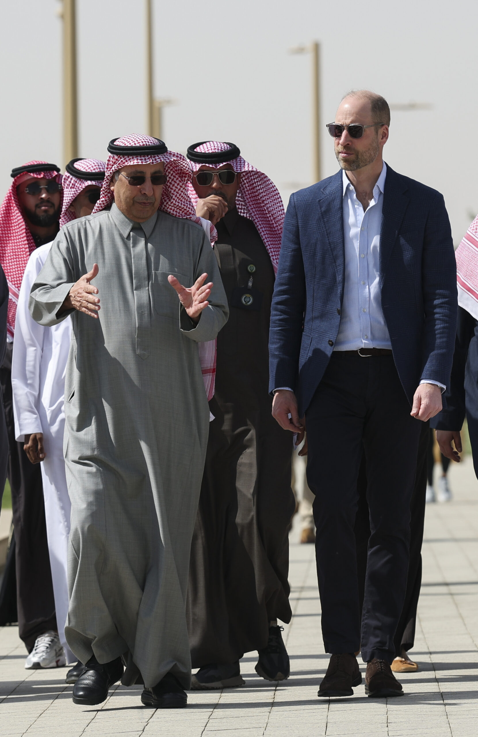 Prince William wearing sunglasses walking with men in Saudi Arabia