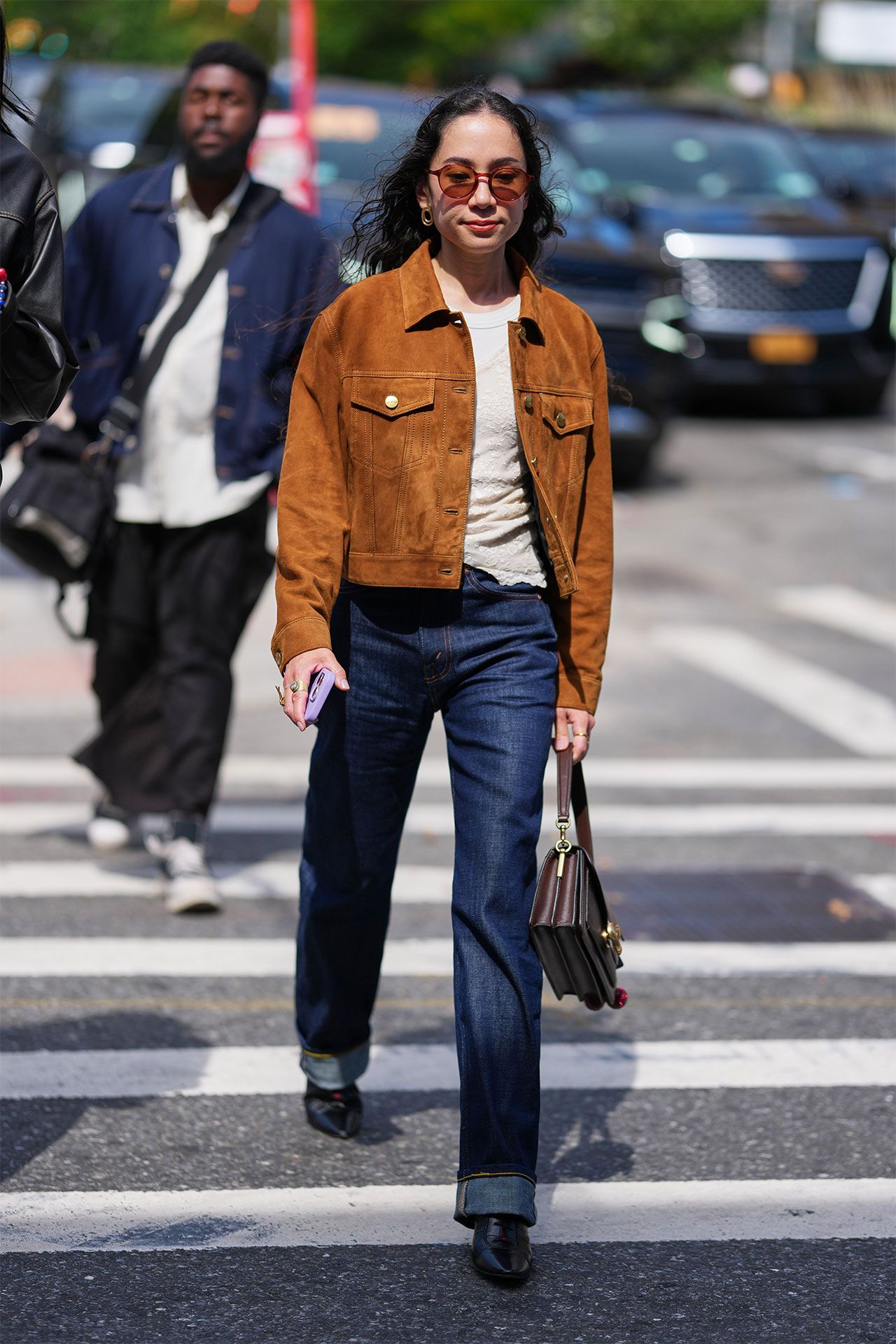 Image may contain Clothing Pants Jeans Pedestrian Person Coat Jacket Accessories Bag Handbag and Adult