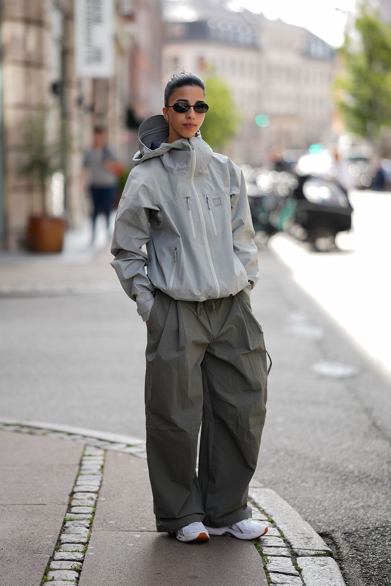 Image may contain María Herrera Clothing Coat Hoodie Knitwear Sweater Sweatshirt Adult Person and Standing