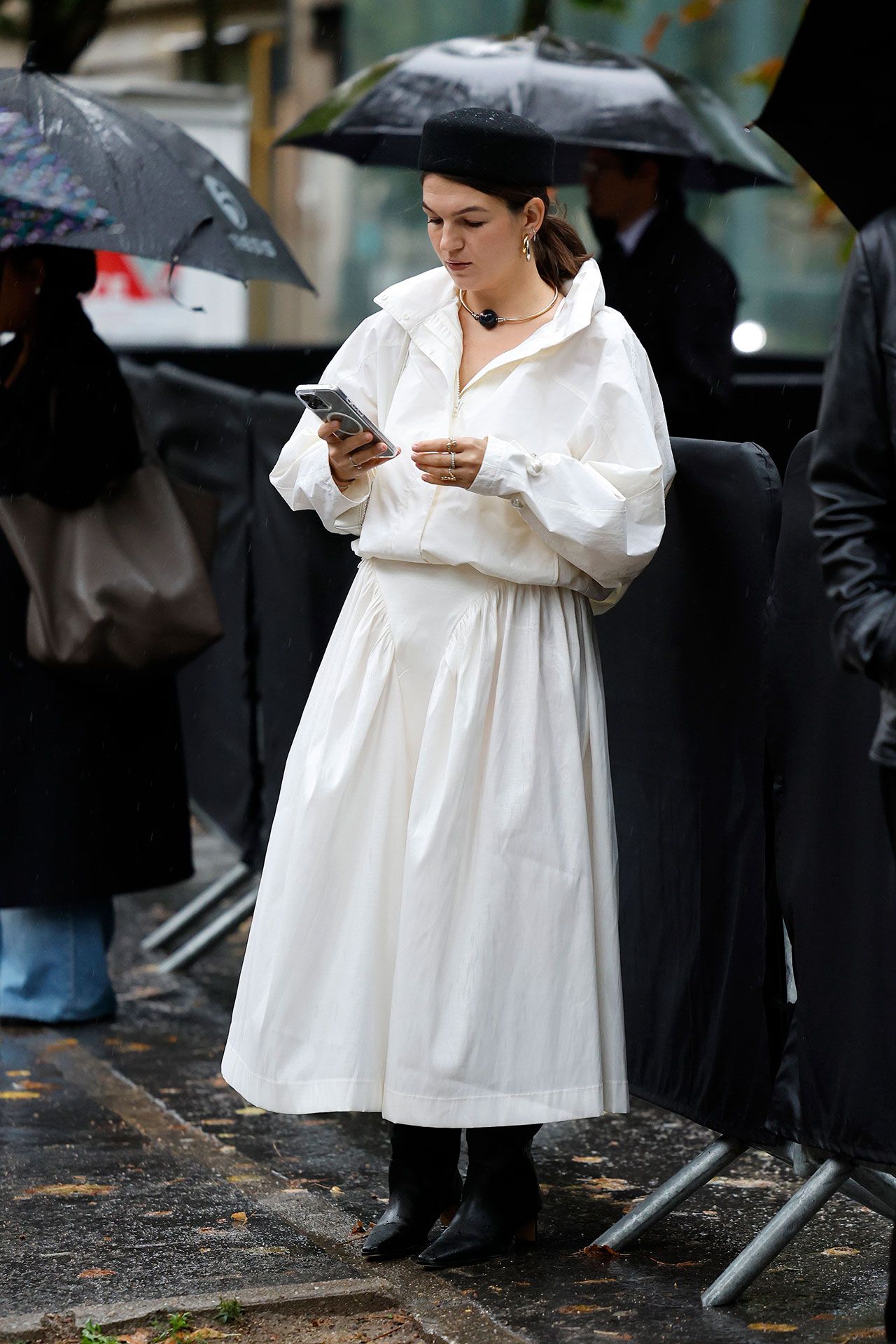 Image may contain Person Adult Clothing Coat Face Head Accessories Bag Handbag Wedding and Electronics