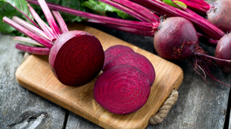 fresh sliced beetroot on wooden surface