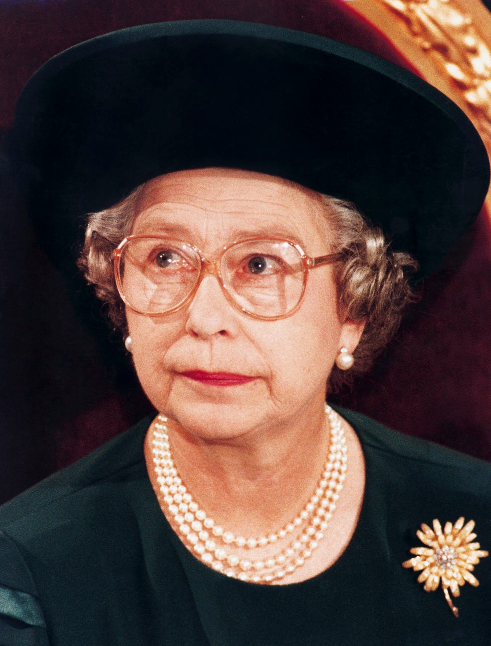 queen elizabeth ii wearing spectacles and looking sad and pensive at the guildhall where she made her annus horribilis speech describing her sadness at the events of the year 2002 which included the marriage breakdown of two of her sons and the devastating fire at her home windsor castle